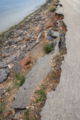 Side of the broken asphalt road collapsed and fallen