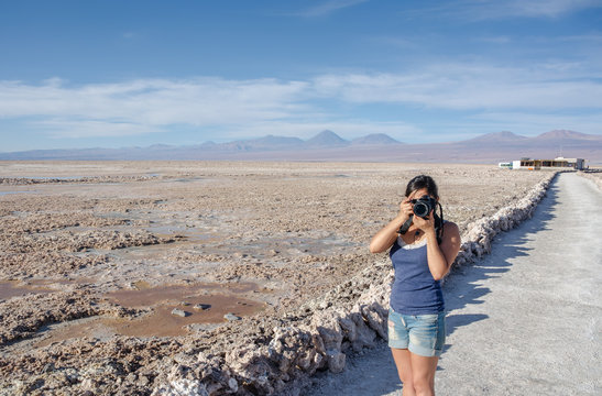 Woman taking photos at Chaxa Lagoon in Atacama Desert, Chile.