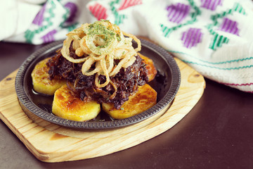 Tasty and juicy meat with onions and fried potato