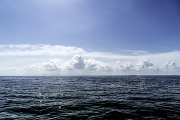 Fototapeta na wymiar Cumulus Clouds On Seaside Horizon