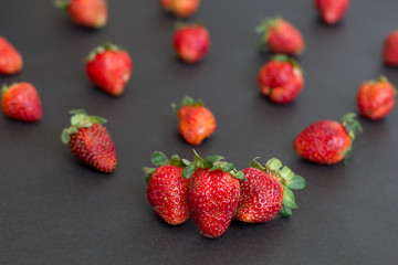 Organic natural strawberries from granny`s garden on black background