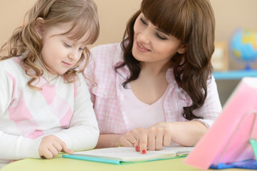 Fototapeta premium Mother and daughter doing lessons 