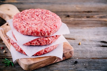 Ingredients for burgers: raw minced beef cutlets