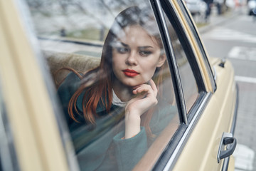 happy woman in the back seat, look out the window, look out