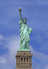 Fototapeta na wymiar Statue of Liberty over blue sky