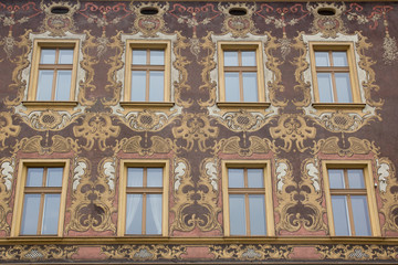 Eight yellow vintage design windows on the painted patterns facade of the old house-4.CR2