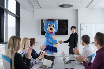 boss dresed as bear having fun with business people in trendy office