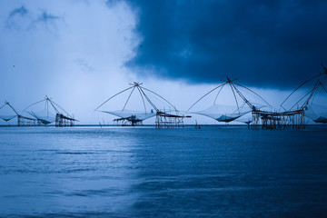 Storm approaching to bamboo fishing net heritage in Baan Pak Pra in Phattalung, Thailand.