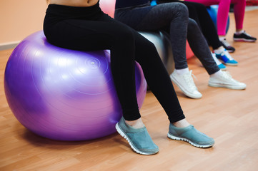 Beautiful caucasian women doing exercise with gymnastic ball.