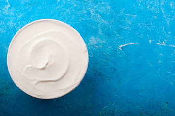 Yogurt on blue background. Dairy product. Healthy food and diet concept. Copy space. Top view