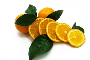 Fresh oranges with green leaves isolated on white.