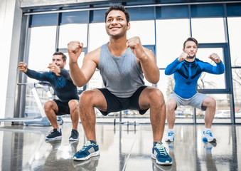 young men exercising at sports center