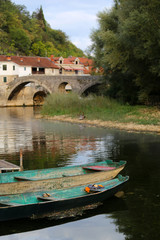 Obraz premium The old town of Rijeka Crnojevica,boats and ancient stone arch bridge