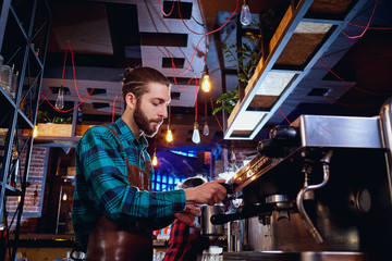 Fototapeta na wymiar Barista bartender barman makes coffee in the bar cafe.