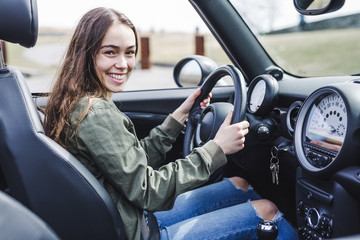 young brunette woman in new car