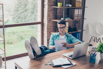 Portrait of smiling freelancer sitting at home in front of computer and writing action plan
