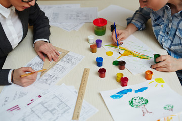 Two types of people opposition: unrecognizable architect working on project with pencil and ruler...