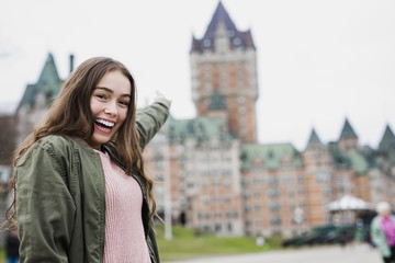 Fototapeta premium Quebec City scape with Chateau Frontenac and young teen enjoying the view.