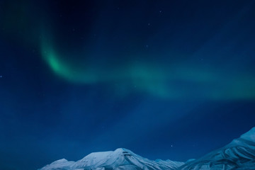 Naklejka na ściany i meble the polar Northern aurora borealis lights in Norway Svalbard in the mountains
