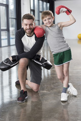 young boy boxer with his coach at training
