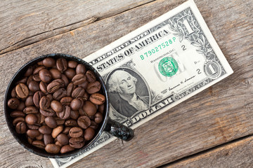Cup of coffee beans on dollar banknote