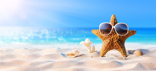 Starfish With Sunglasses On The Sunny Beach
