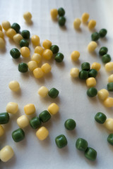 Small yellow and green colored candy drops (vertical)