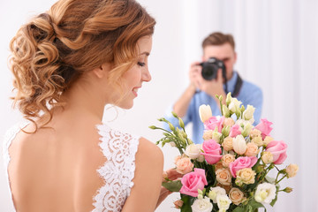 Wedding photographer taking photo of beautiful bride in studio - obrazy, fototapety, plakaty