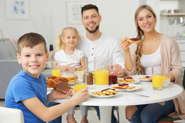 Obraz na płótnie Canvas Happy family having breakfast on kitchen