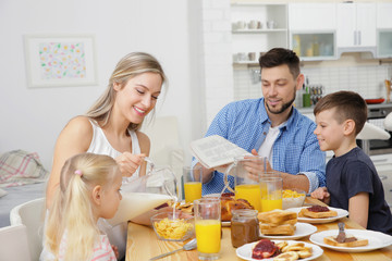 Happy family having breakfast on kitchen