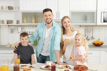 Happy family having breakfast on kitchen