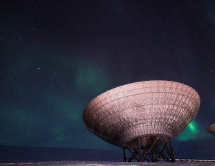 The polar Northern aurora borealis lights in Norway Svalbard in the mountains