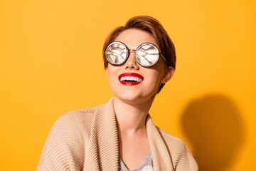 Reflection in glasses! Amazing look of a young girl with nice smile wearing stylish sunglasses and casual clothes on the bright yellow background
