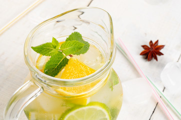 Jug with Lime and Orange Fruit Water with ice