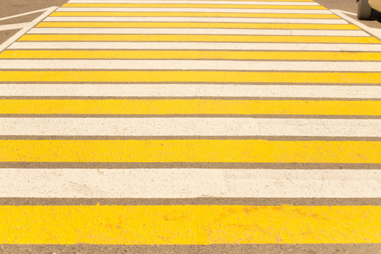 Large pedestrian crossing striped white and yellow.