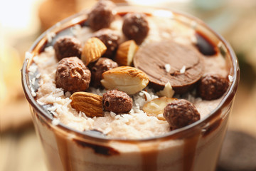 Glass of tasty cocoa drink on blurred background, closeup