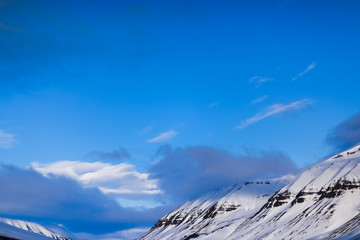 Winter mountain nature Svalbard Longyearbyen Svalbard Norway with blue sky and snowy peaks and blue sky on a sunny day with clouds wallpaper