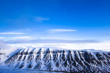 Winter mountain nature Svalbard Longyearbyen Svalbard Norway with blue sky and snowy peaks and blue sky on a sunny day with clouds wallpaper