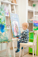 a child draws a picture paints on art lesson