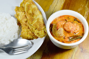 fried egg  on rice eat couple with spicy prawn Tom Yum soup