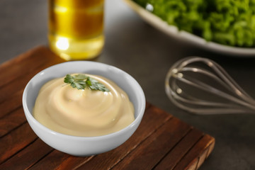 Delicious mayonnaise in bowl on kitchen table