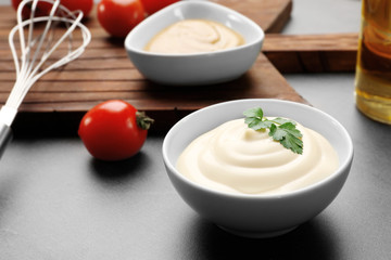 Delicious mayonnaise in bowl on kitchen table