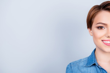 Cropped close up portrait of young beautiful girl on pure blue background. She is wearing casual shirt and smiling