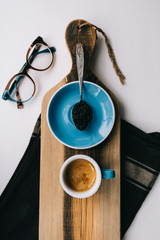Delicious fresh morning coffee with beautiful thick crema, glasses and a spoon full of Ossetra black caviar, on the rustic wooden board background, horizontal photo