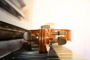 Fototapeta na wymiar Violin on piano keys, closeup