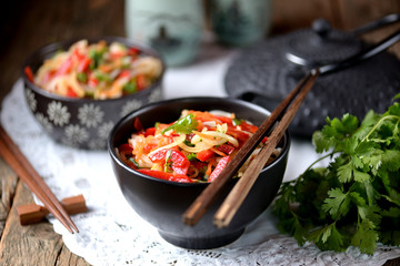 Rice noodles with onions, carrots, cucumber, peppers and coriander. Eastern cuisine.