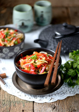 Rice noodles with onions, carrots, cucumber, peppers and coriander. Eastern cuisine.