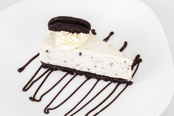 Creamy cheesecake with chocolate biscuits. Isolate. White background. Selective focus
