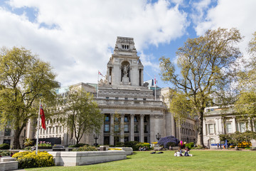 Trafalgar Square full of people walking along with the tourists taking photos