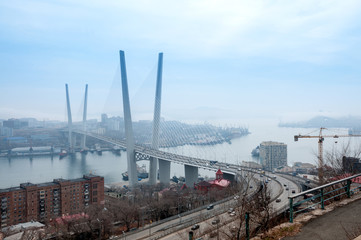 Fototapeta na wymiar Russia, Vladivostok, April 8: Bridge over Golden Horn Bay